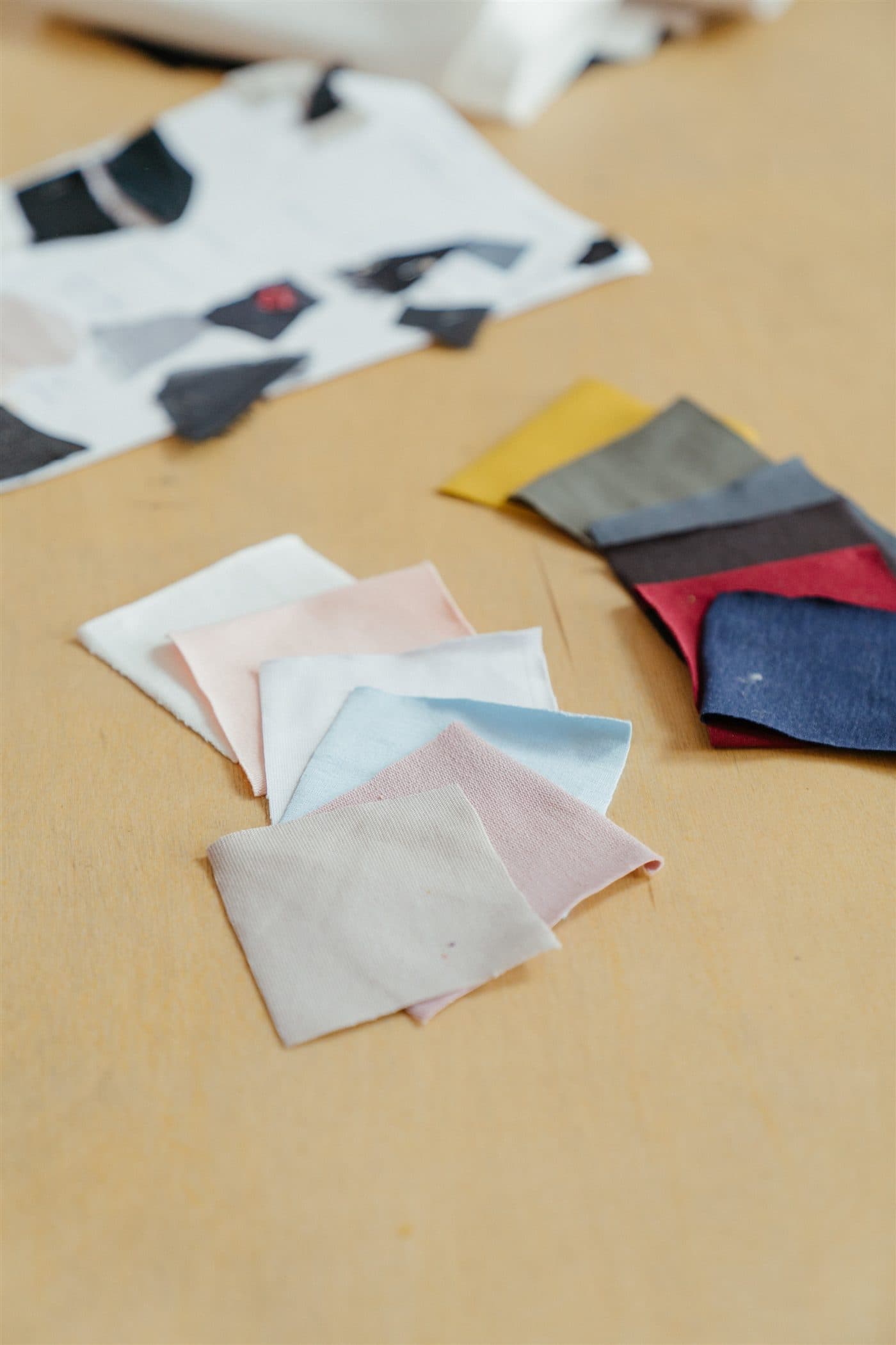 Assorted fabric swatches arranged on a worktable